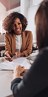 Young woman doing a job interview in the office and talking with client